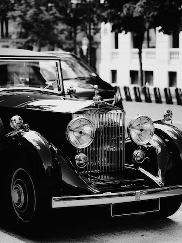 Black Vintage Car Driven By Chauffeur