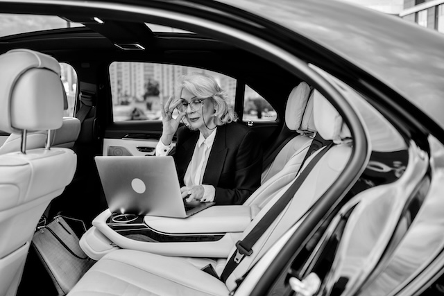 Professional Woman Working On Laptop In Private Car