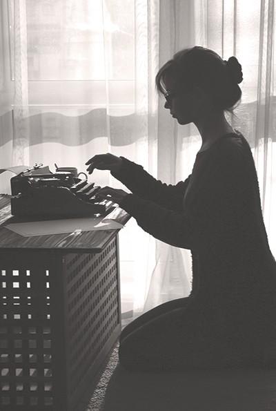 Experienced Personal Assistant Working On A Typewriter