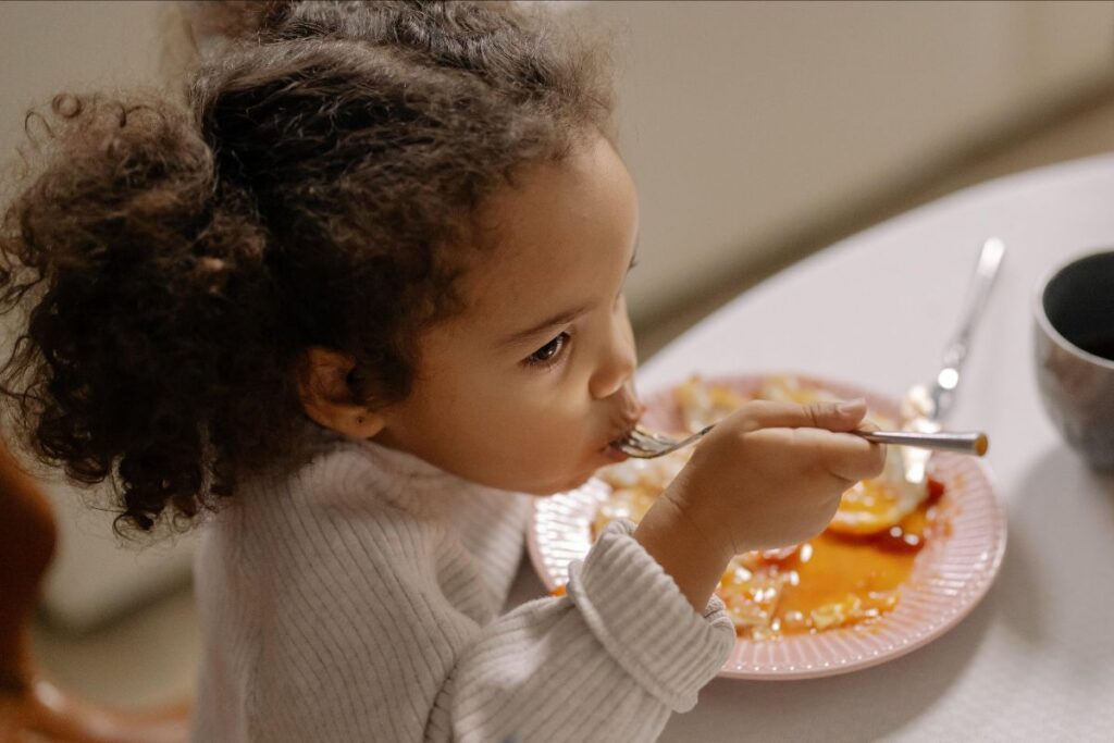 Child Eating In A Restaurant