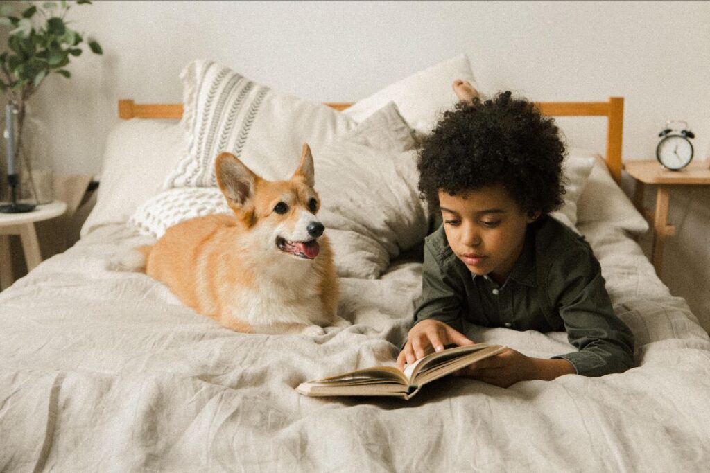 Child Reading Book To A Dog