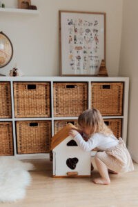 Child Playing Alone With Toy House
