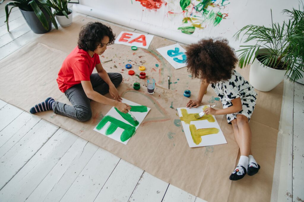 Children Painting In A Montessori Environment