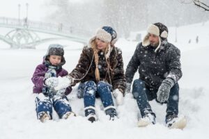 Family Playing Outside In The Snow