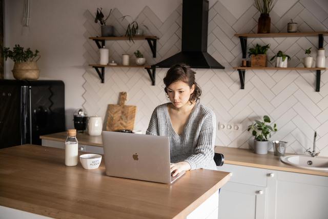 Employer Looking At Candidate Resumes On Laptop