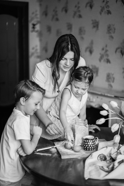Nanny Cooking With Two Children In A Modern San Francisco Kitchen.