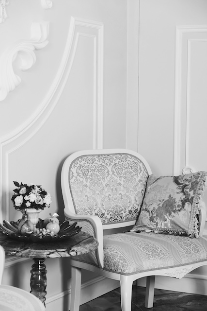 Antique Armchair By Table With Flowers In NYC Apartment