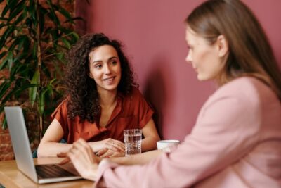 Recruiter And Candidate Sitting Down Reviewing Application