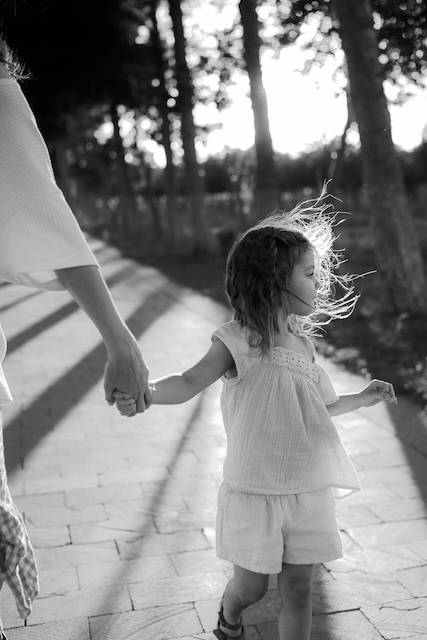 Caregiver And Child Holding Hands Walking In Austin