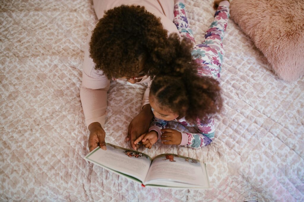 Caregiver and Child Reading Book Together