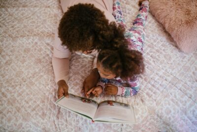 Caregiver and Child Reading Book Together