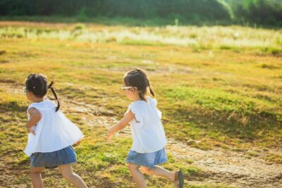 Two Children Running Outdoors