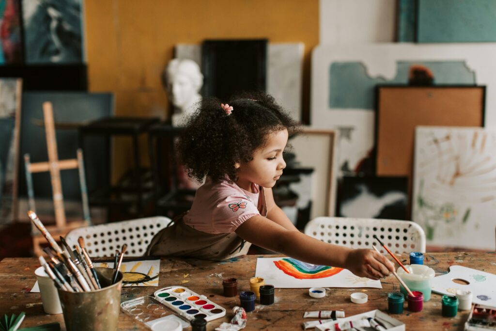 Young Child Painting With Paintbrush