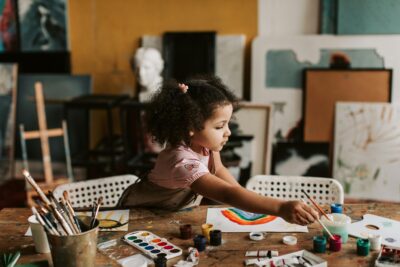 Young Child Painting With Paintbrush