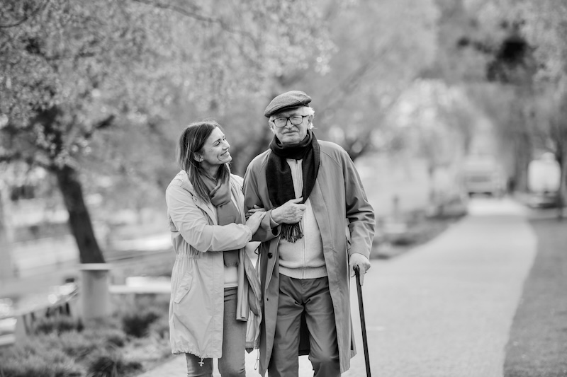 Caregiver And Senior Taking A Walk Together