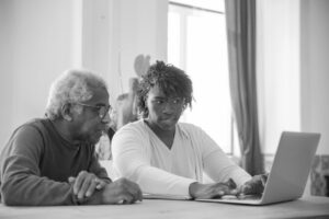 Caregiver Helping Senior Use Laptop